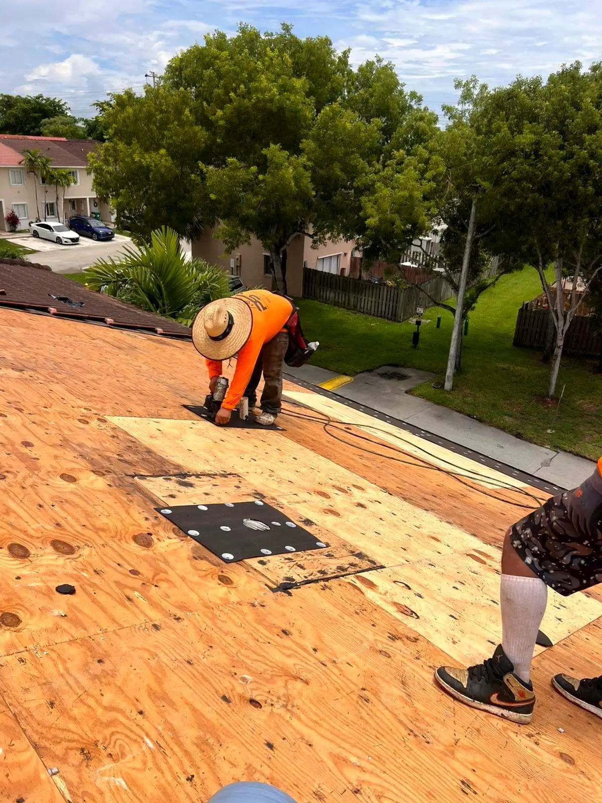 PSR crew member working on a plywood roof deck