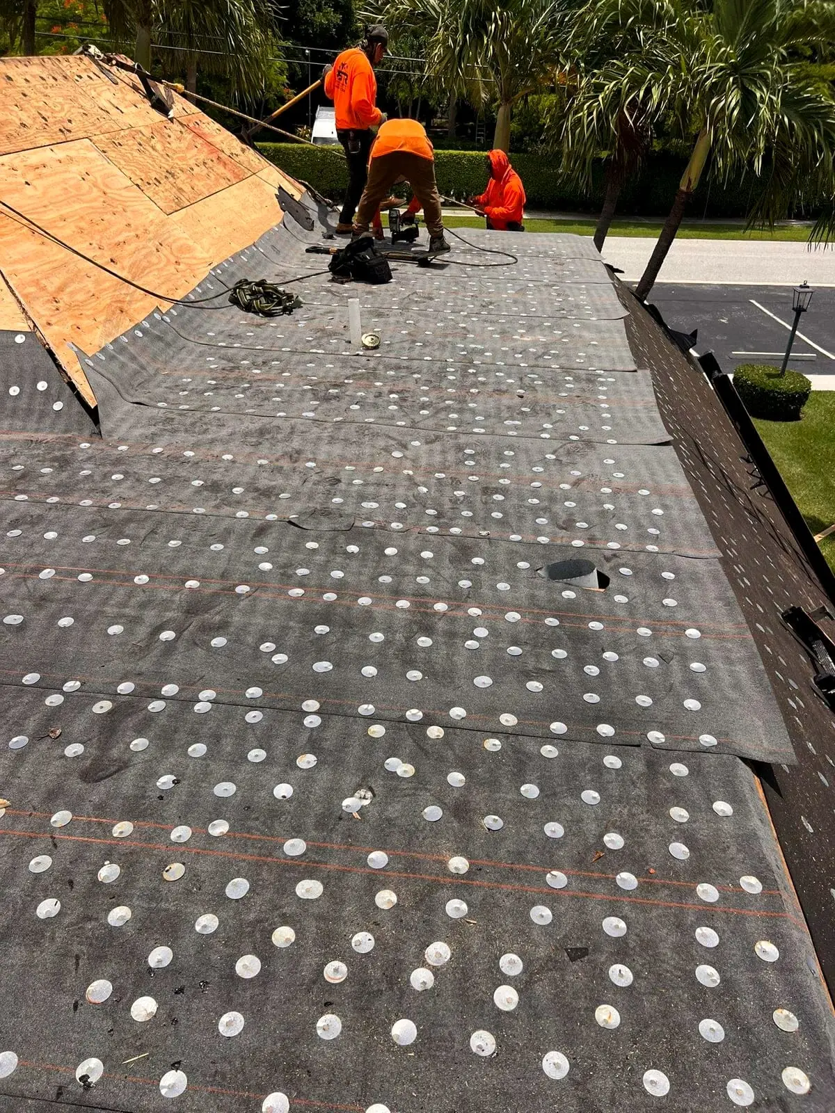 PSR crew laying underlayment across a roof